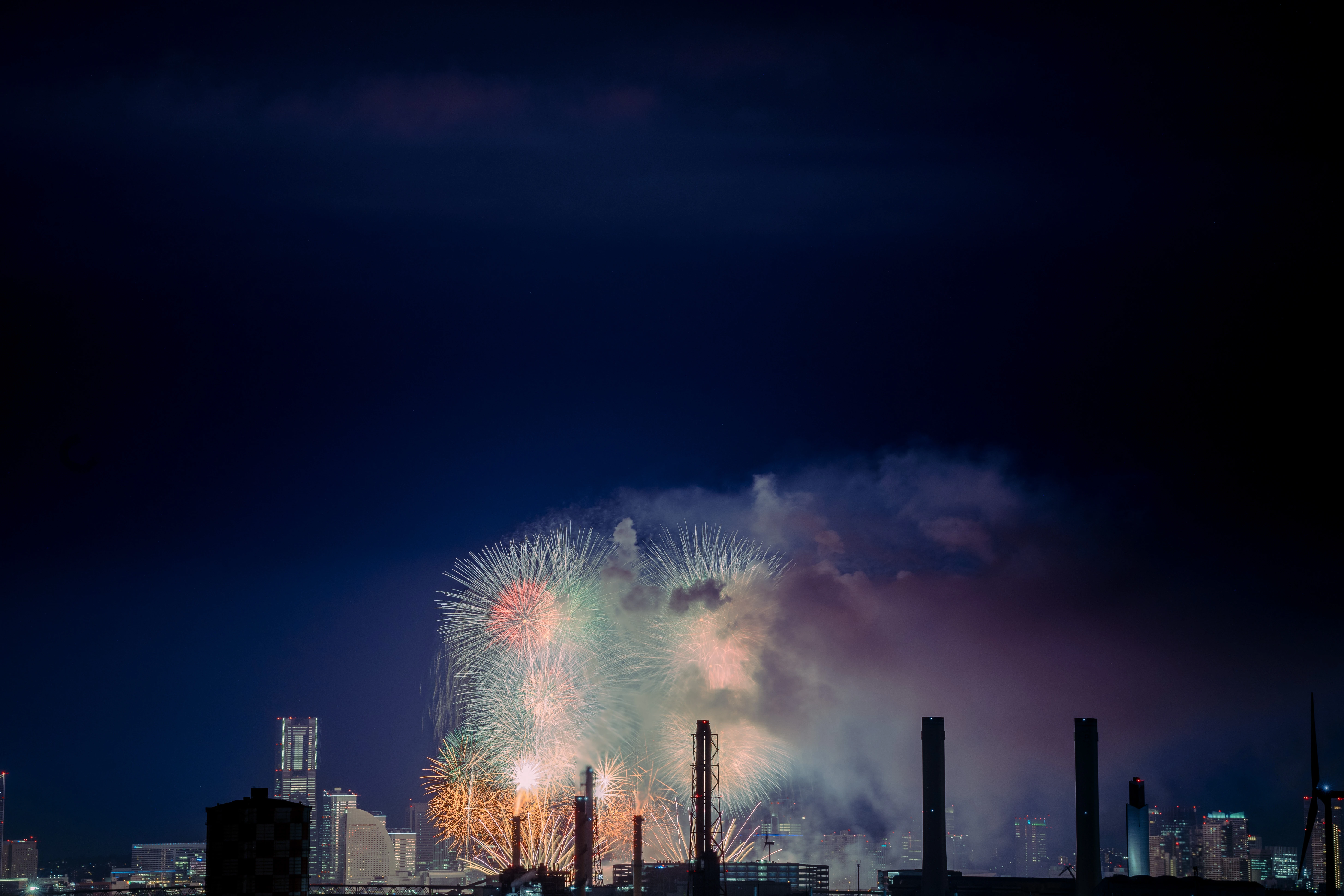 Nighttime Fireworks Illuminating the Urban Skyline